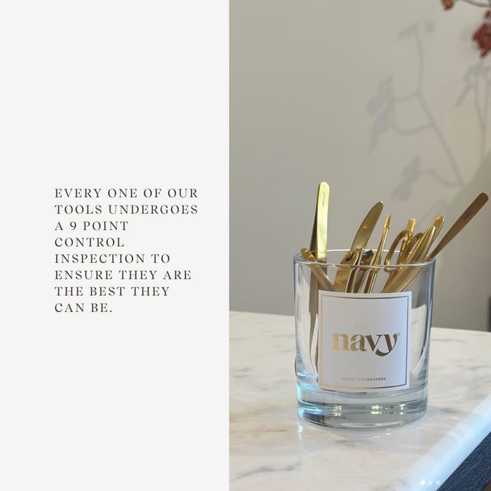 Glass container with gold tools on a marble surface, text about tool inspection.