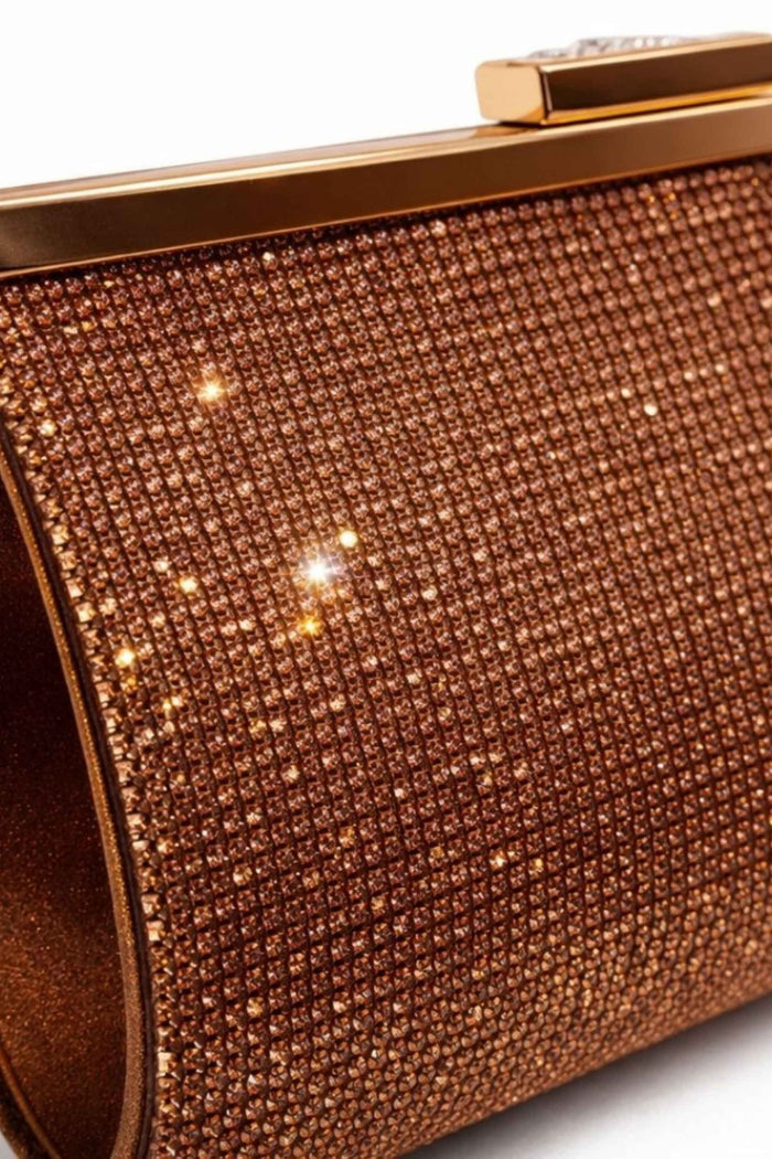Structured bronze clutch bag with a sparkling rhinestone exterior, gold-tone clasp closure, ideal for formal occasions and evening wear.