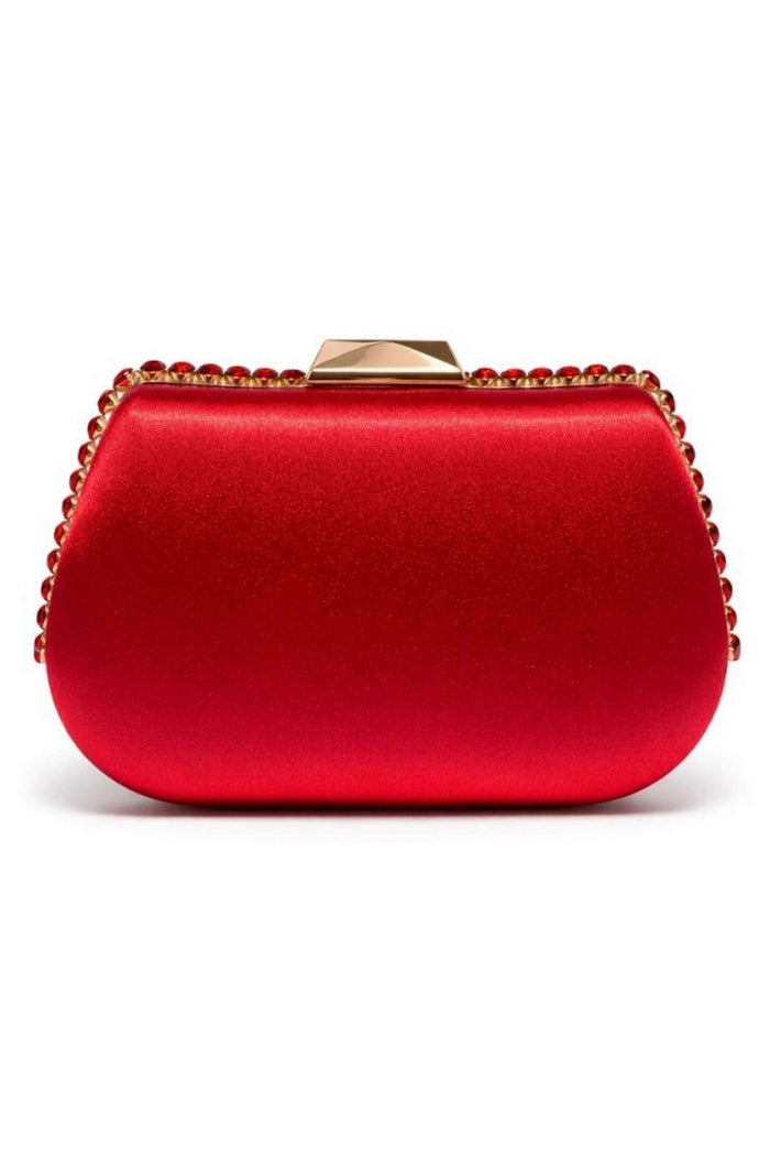 Close-up of a red satin clutch with a structured rounded shape, embellished with a gold-tone border of red gemstones, featuring a gold clasp on top.