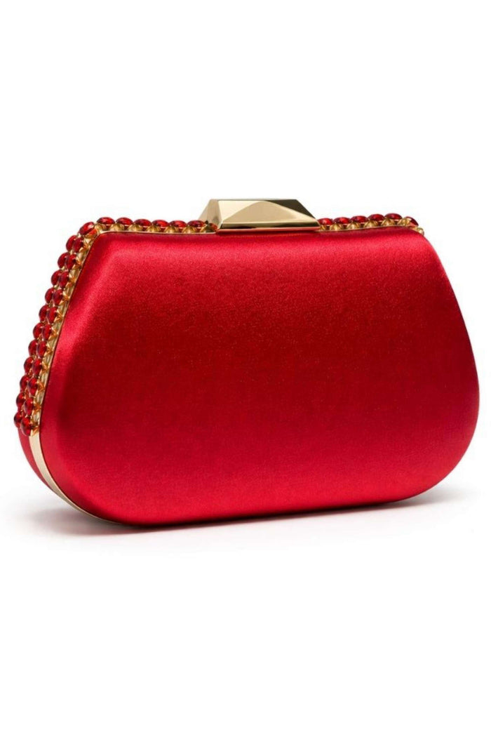 Detailed view of the red satin clutch's textured surface and gold-tone border of red gemstones, highlighting its elegant design and luxurious finish.