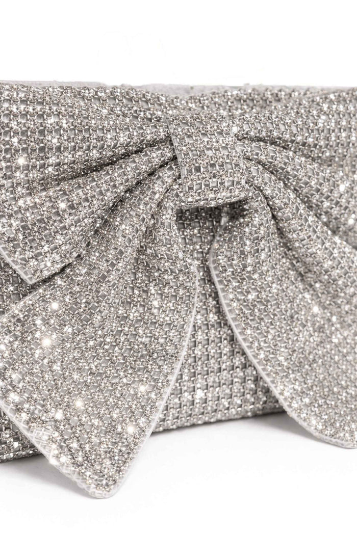 Close-up of the silver bead embellishments on the clutch, showcasing the intricate pattern and sparkling texture of the silver beads and bow detail.