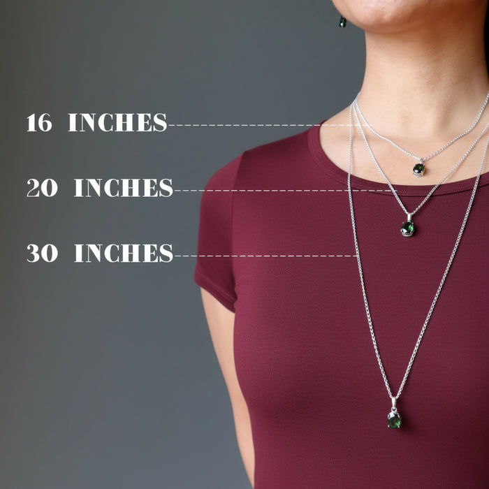 woman modeling three moldavite necklaces to show different lengths