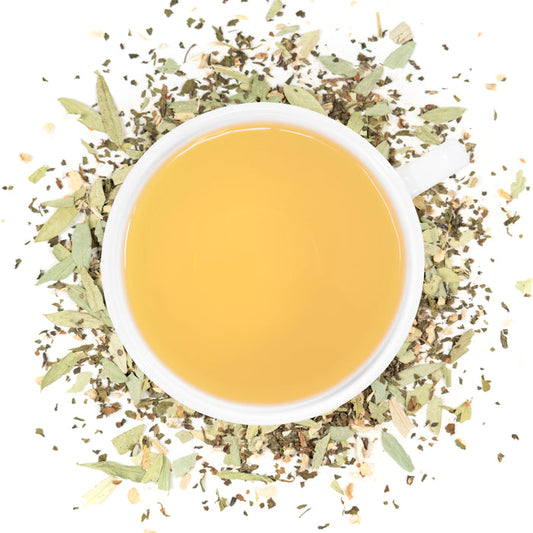 A white cup of Organic Constipation Relief tea surrounded by the loose leaf blend.