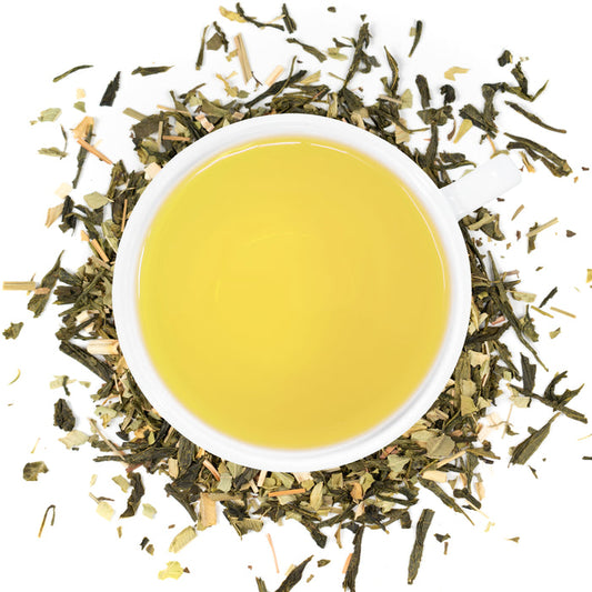A white cup of Organic Jade Bliss surrounded by the loose leaf blend.