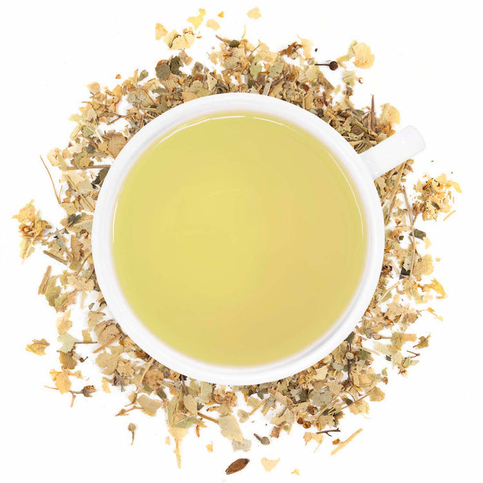 A cup of brewed Organic Linden Leaf tea with visible dried Linden leaves around it.