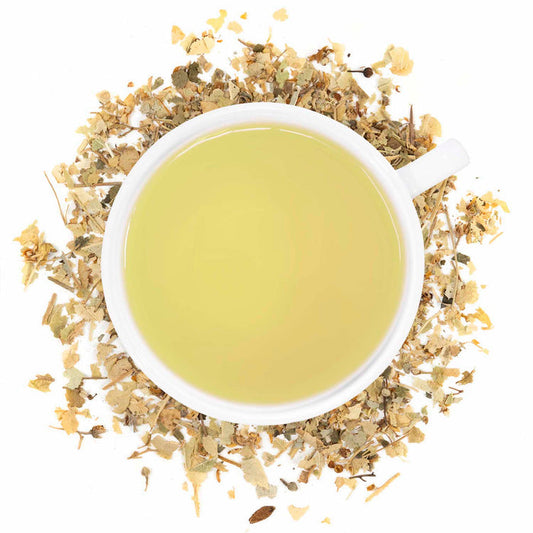 A cup of brewed Organic Linden Leaf tea with visible dried Linden leaves around it.