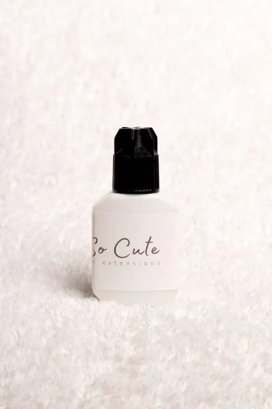 A white 10ml eyelash primer bottle with a black cap and so cute extensions for lash extension retention