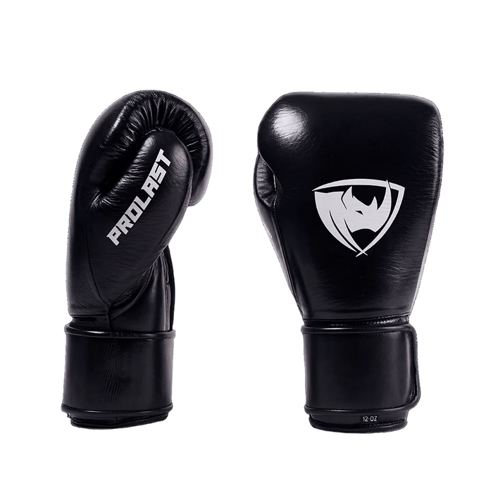 PROLAST PG professional boxing gloves in charcoal black with Velcro strap, pair showing the PROLAST thumb side and rhino logo