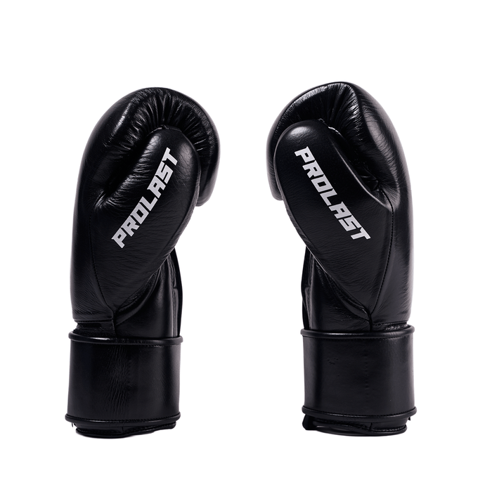 PROLAST PG professional boxing gloves in charcoal black with Velcro strap, pair side view with white PROLAST lettering