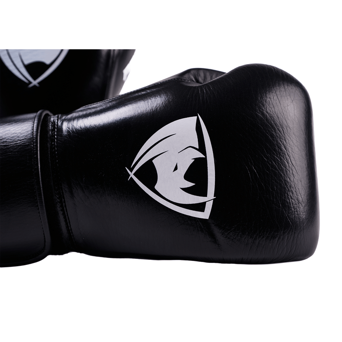 PROLAST PG professional boxing gloves in charcoal black, close-up of the white rhino logo and Velcro wrist strap