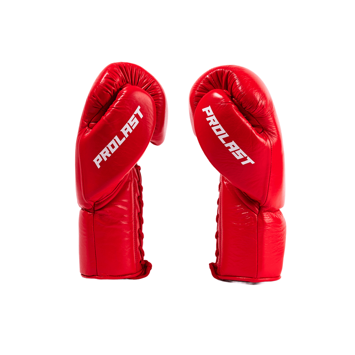 PROLAST PG professional lace-up boxing gloves in crimson red, pair side view with white PROLAST lettering and red laces
