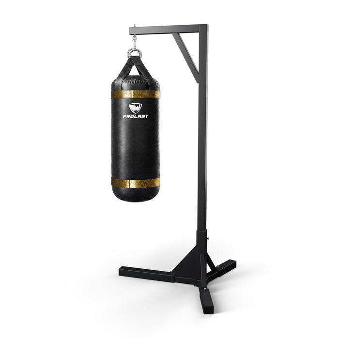 PROLAST 4 ft XL 135 lb stock heavy bag, black with gold trims, hanging from a PROLAST single bag stand on a steel snap hook through its D-rings (stand sold separately)