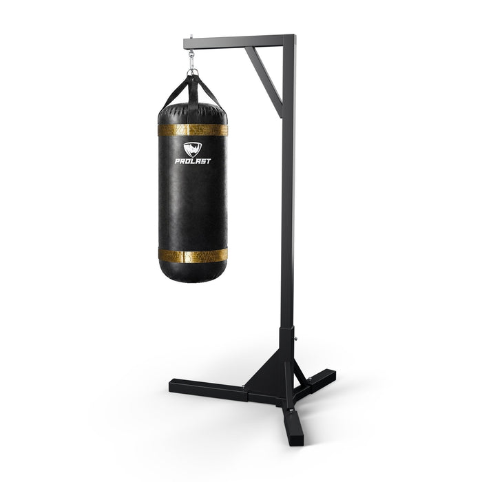 PROLAST 4 ft XL 150 lb stock heavy bag, black with gold trims, hanging from a PROLAST single bag stand on a steel snap hook through its D-rings (stand sold separately)