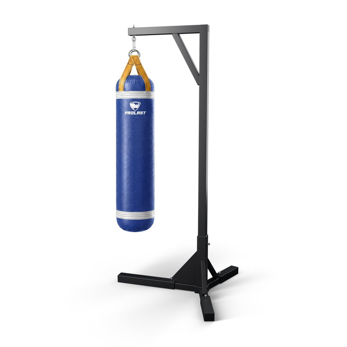 PROLAST 5 ft 100 lb stock heavy bag, royal blue with white trims and yellow straps, hanging from a PROLAST single bag stand on a steel snap hook through its D-rings (stand sold separately)