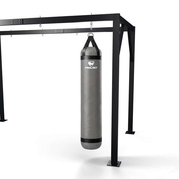 PROLAST 6 ft 150 lb stock heavy bag, smoke grey, hanging from a PROLAST heavy bag frame on a steel snap hook through its D-rings (stand sold separately)