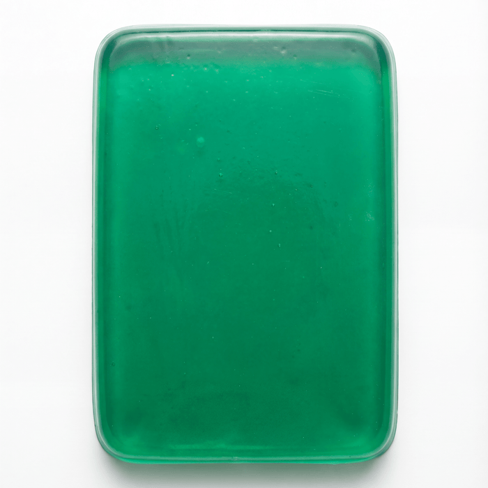 PROLAST x Skulltec gel knuckle guard in green, a single translucent gel pad out of its pack