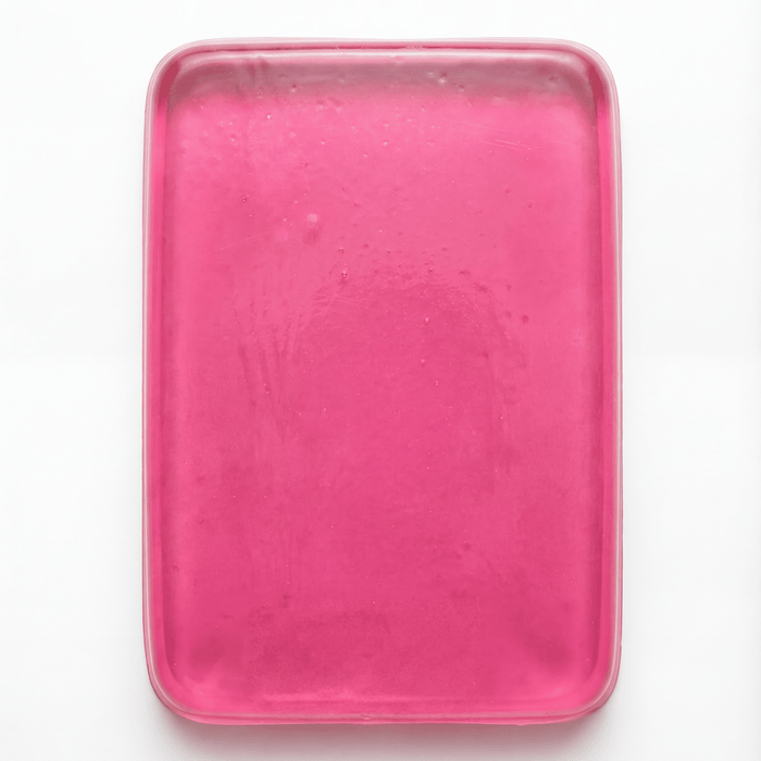 PROLAST x Skulltec gel knuckle guard in pink, a single translucent gel pad out of its pack