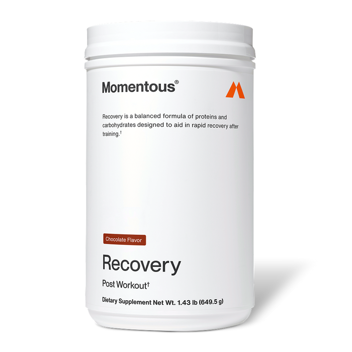 White Momentous Recovery container labeled “Chocolate Flavor.” Text reads: “Momentous. Recovery is a balanced formula of proteins and carbohydrates designed to aid in rapid recovery after training. Recovery. Post Workout†. Dietary Supplement Net Wt. 1.43 lb (649.5 g).”