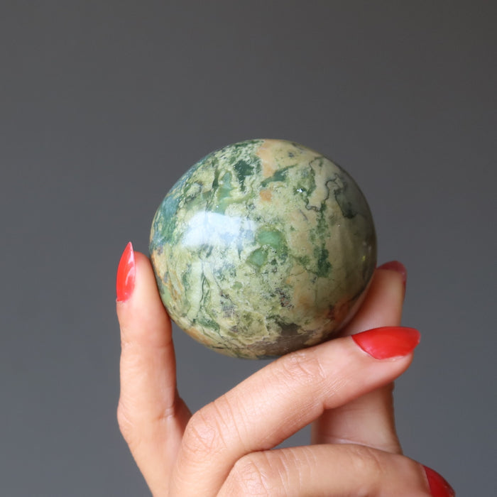 hand holding Serpentine Sphere