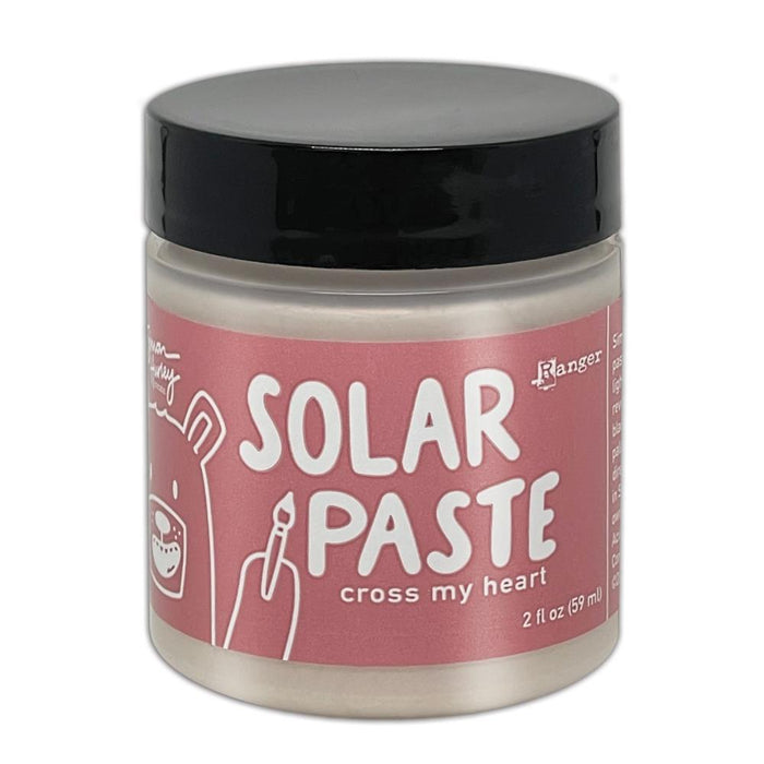 Simon Hurley  create. - Solar Paste - 2oz - Cross My Heart. A creamy white paste with a metallic color shift when it hits the light. Color can be subtle on white cardstock but reveals an intense colored shine when applied to black. Available at Embellish Away located in Bowmanville Ontario Canada.