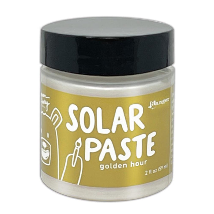 Simon Hurley  create. - Solar Paste - 2oz - Golden Hour. A creamy white paste with a metallic color shift when it hits the light. Color can be subtle on white cardstock but reveals an intense colored shine when applied to black. Available at Embellish Away located in Bowmanville Ontario Canada.