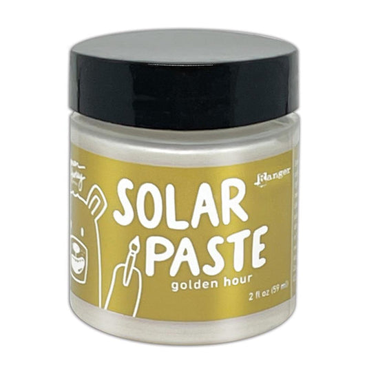 Simon Hurley  create. - Solar Paste - 2oz - Golden Hour. A creamy white paste with a metallic color shift when it hits the light. Color can be subtle on white cardstock but reveals an intense colored shine when applied to black. Available at Embellish Away located in Bowmanville Ontario Canada.