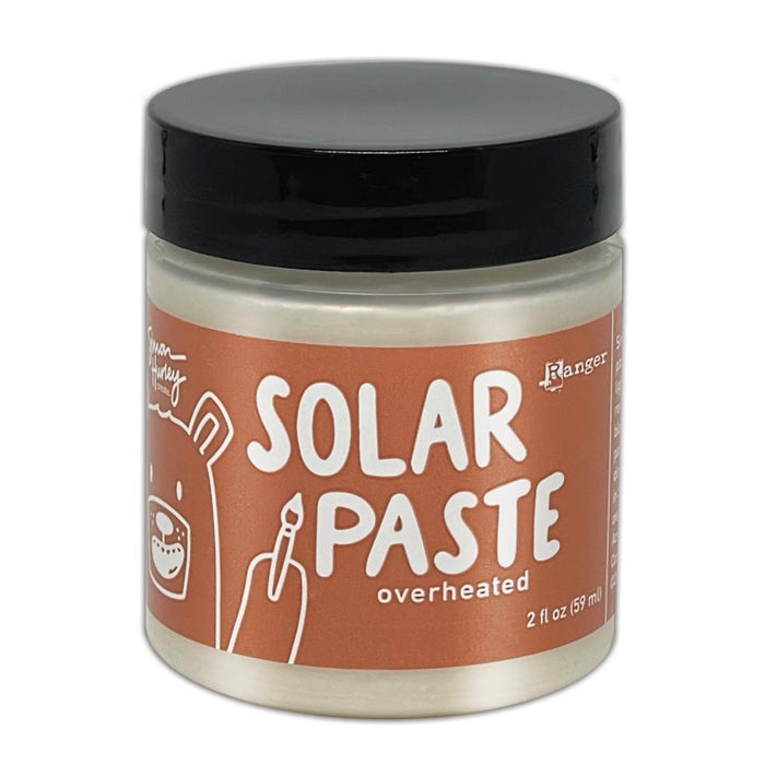 Simon Hurley  create. - Solar Paste - 2oz - Overheated. A creamy white paste with a metallic color shift when it hits the light. Color can be subtle on white cardstock but reveals an intense colored shine when applied to black. Available at Embellish Away located in Bowmanville Ontario Canada.