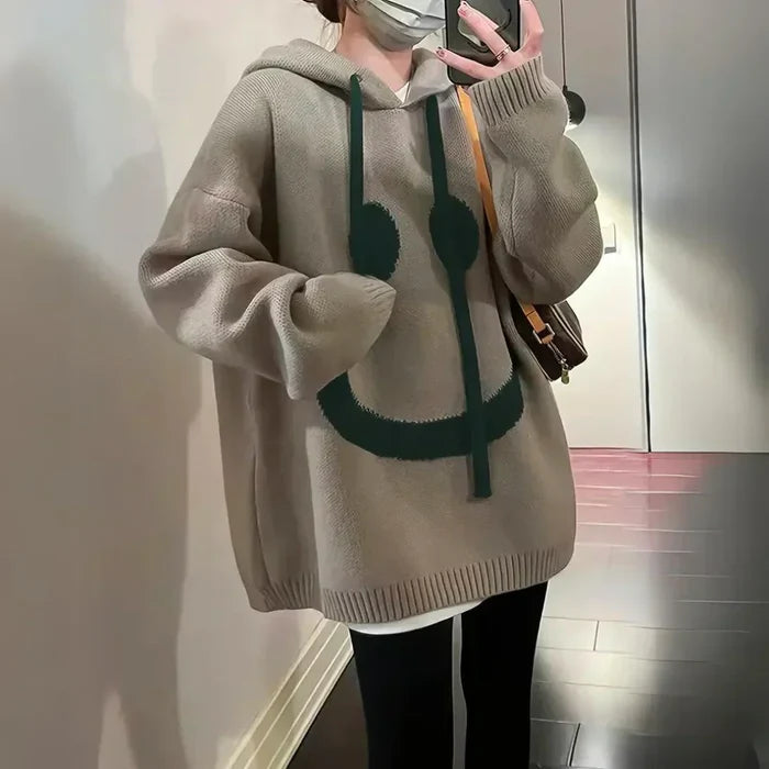 Cozy oversized hoodie with playful smiley design in khaki and black