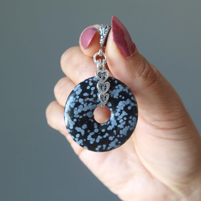 hand holding Snowflake Obsidian Pendant