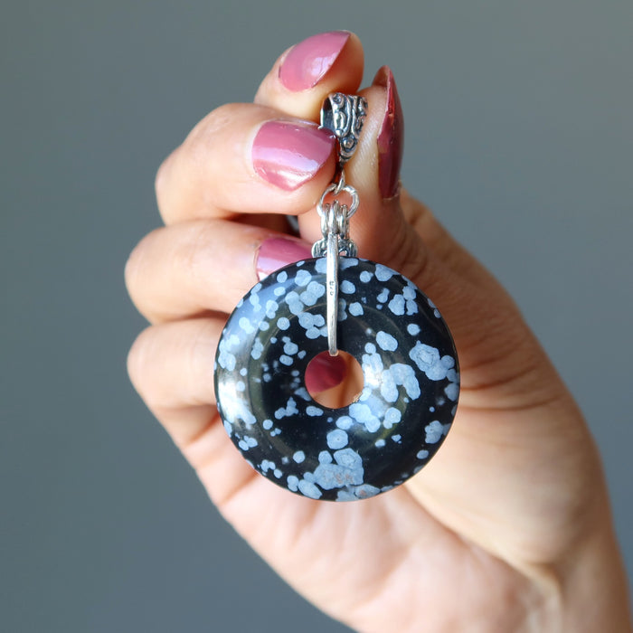 hand holding Snowflake Obsidian Pendant
