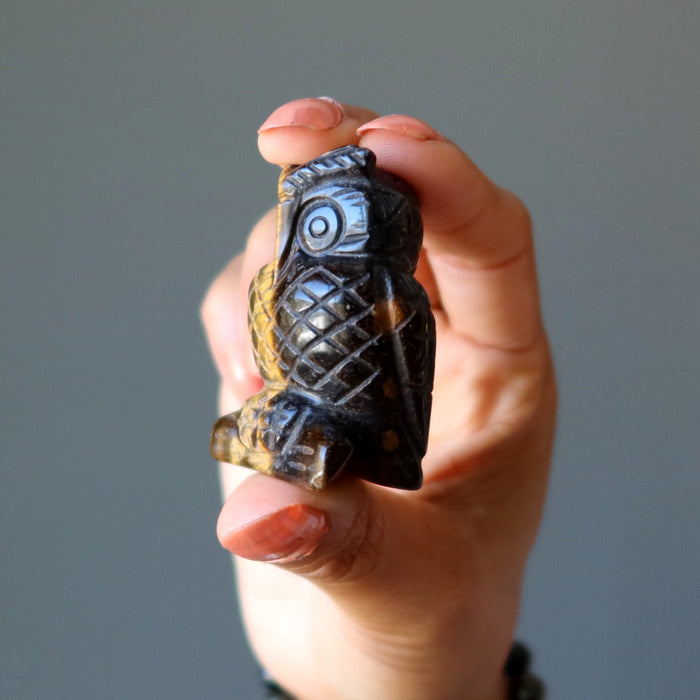 hand holding Tigers Eye Owl