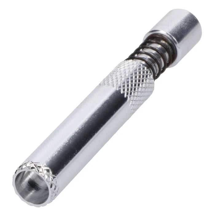 A close-up, angled view of the silver Valiant Spring Loaded Half Weave Tip One Hitter, showcasing its textured metal construction.
