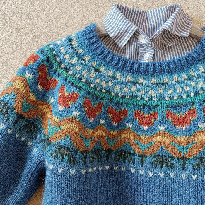 Blue vintage Nordic knit sweater with classic patterned design and relaxed fit