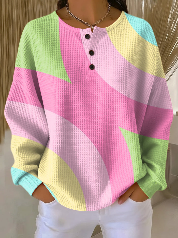 Pink waffle-knit women's sweater with abstract geometric pattern and relaxed fit