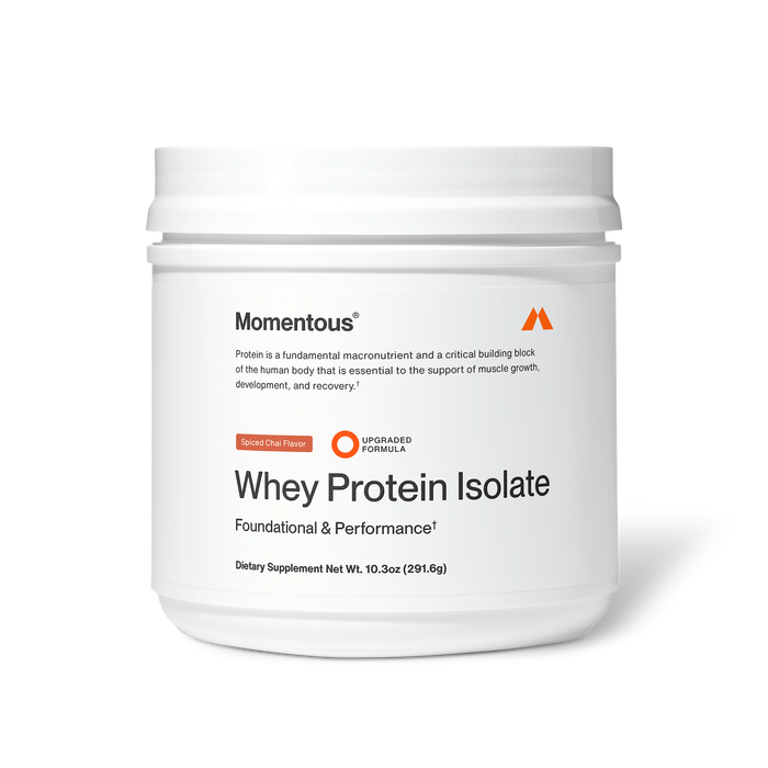 Momentous Whey Protein Isolate dietary supplement in spiced chai flavor, white plastic tub, 10.3 oz (291.6 g), labeled “Foundational & Performance” with upgraded formula badge; packaging states protein is a fundamental macronutrient and critical building block essential for supporting muscle growth, development, and recovery