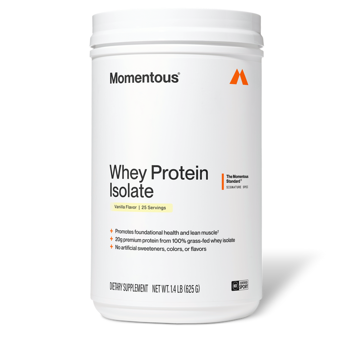 Momentous Whey Protein Isolate tub, Vanilla Flavor, 25 Servings, front-facing product shot. Label reads "The Momentous Standard – Signature Spec" with claims "Promotes foundational health and lean muscle," "20g premium protein from 100% grass-fed whey isolate," "No artificial sweeteners, colors, or flavors." Net Wt. 1.4 lb (625 g), NSF Certified Sport badge.